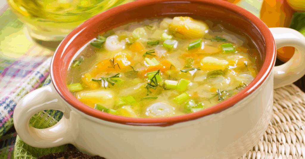 Bowl of hearty zero-point vegetable soup with carrots, zucchini, tomatoes, and green beans.