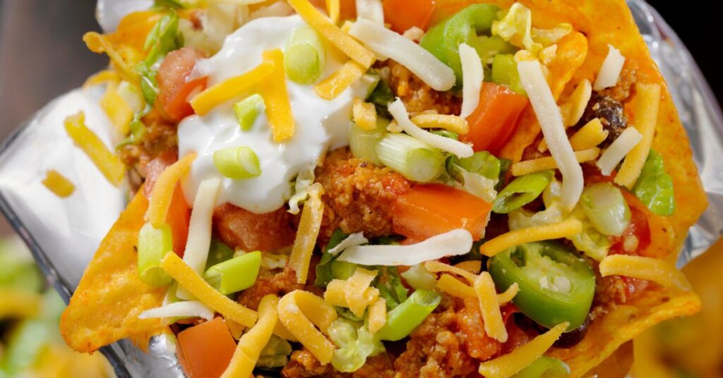 Mexi protein power bowl with ground turkey, black beans, cauliflower rice, lettuce, tomatoes, cheese, and Greek yogurt.