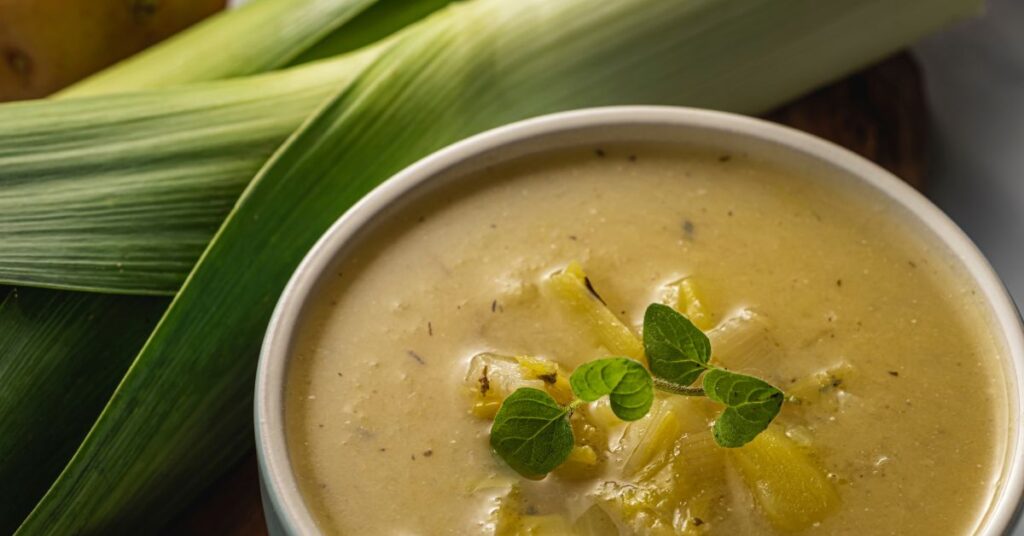 Bowl of zero-point Weight Watchers potato soup with carrots, celery, and herbs