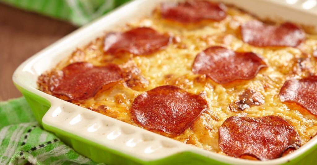 Cheesy WW-friendly pizza bake with turkey, olives, and pepperoni.