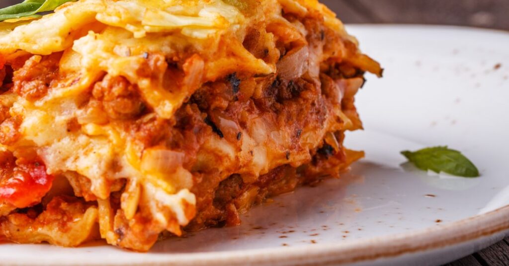 Low-calorie lasagna with Egglife wraps and melted mozzarella in baking dish, healthy WW version
